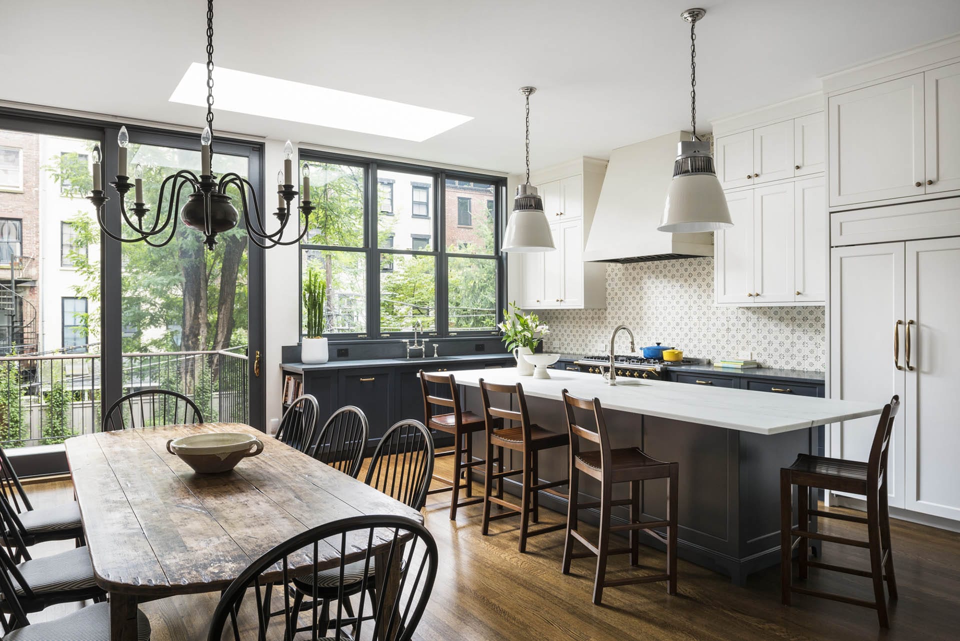 Traditional kitchen and dining area at the rear of a Brooklyn Heights townhouse. A skylight allows light into the rear extension.