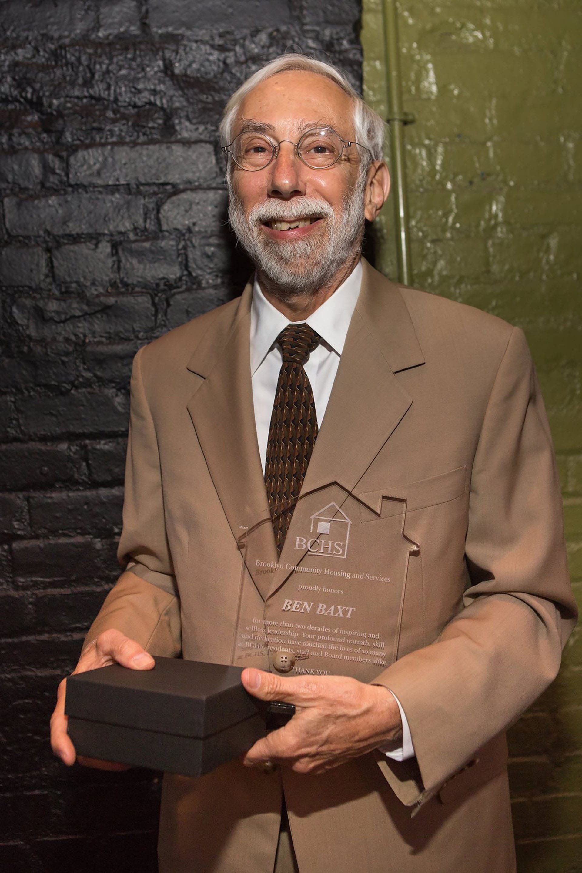 Ben Baxt holding the award he received at the 2015 Brooklyn Community Housing and Services Gala.