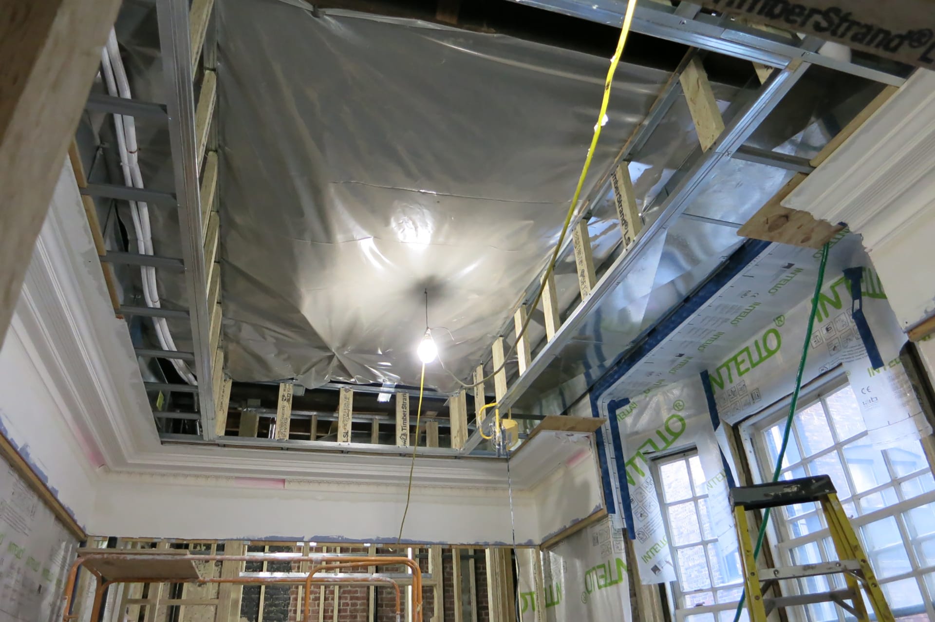 Ceiling of a primary suite walk-in closet, which will become a tray ceiling with plaster details