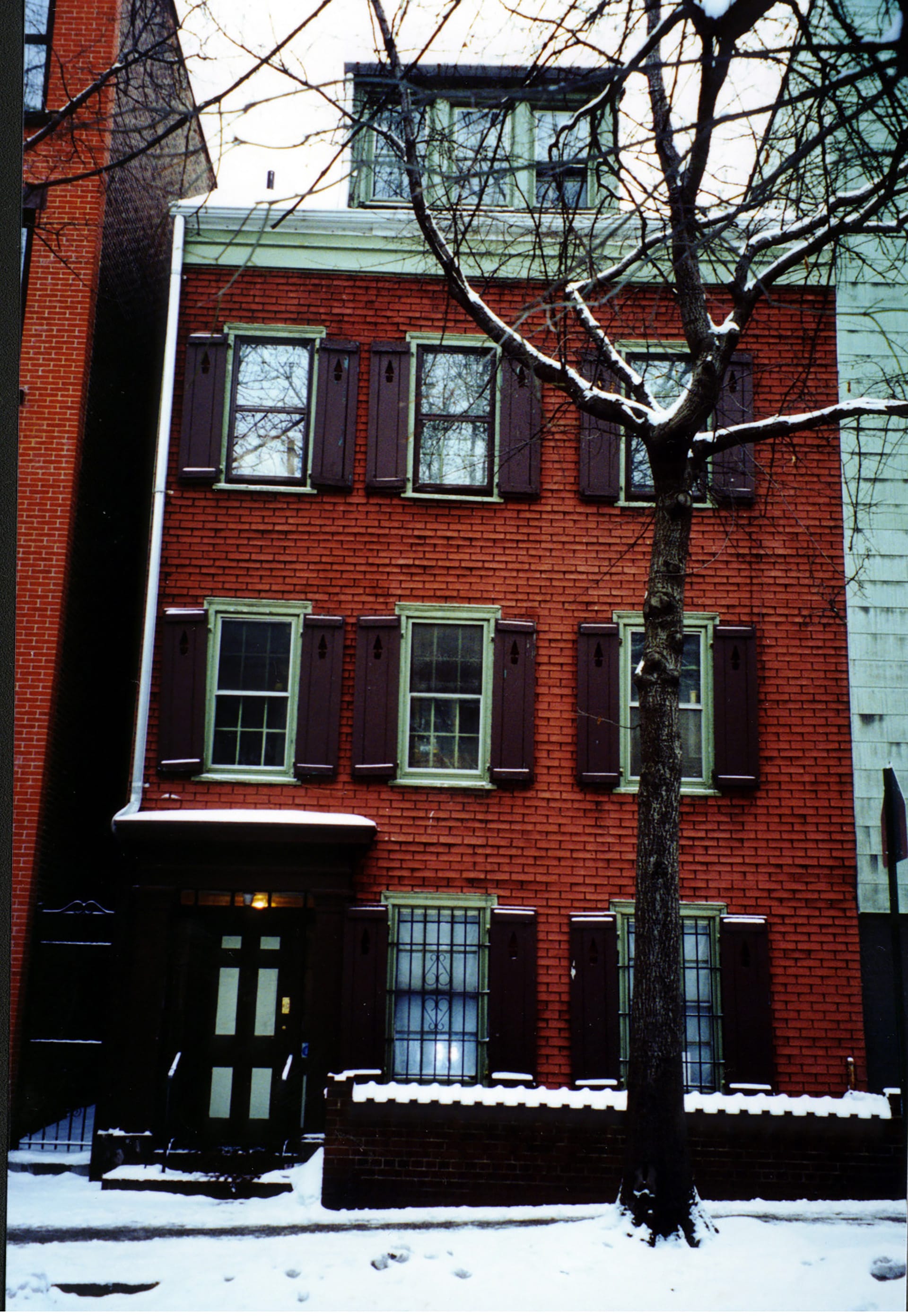 Front facade before renovation with red brick veneer siding