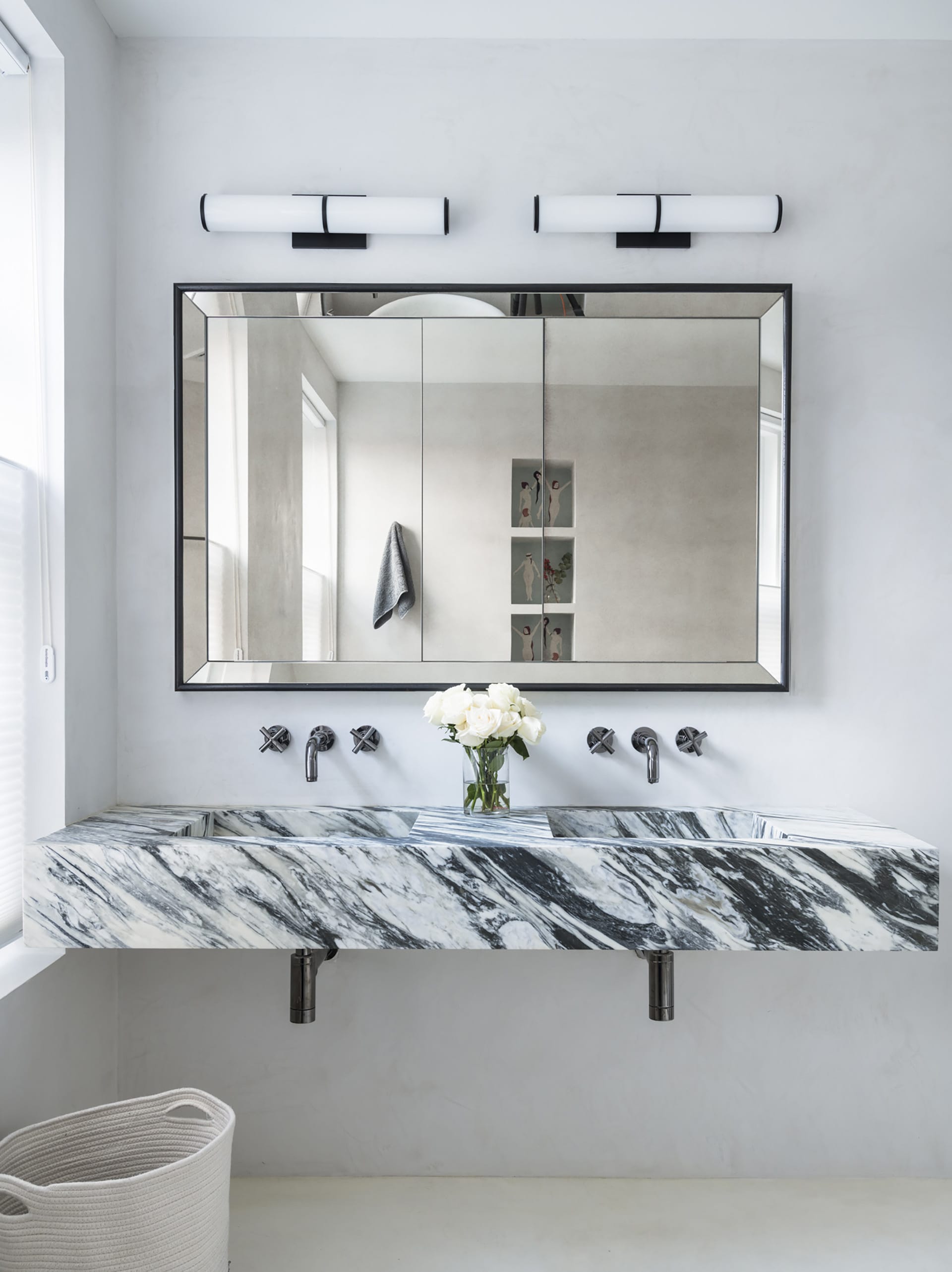 Primary bath with bold marble Jack and Jill vanity