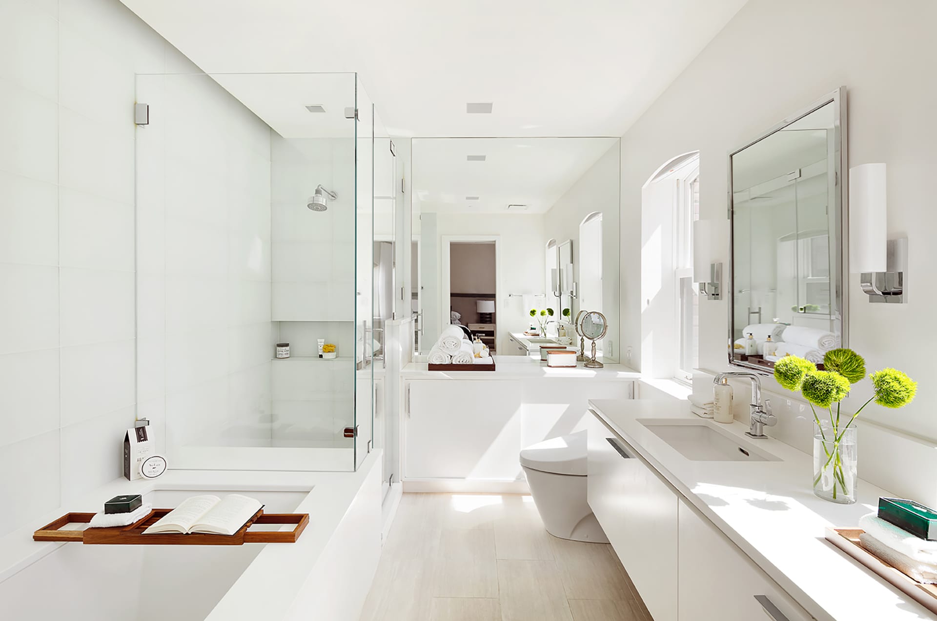 All-white primary bathroom with chrome furnishings