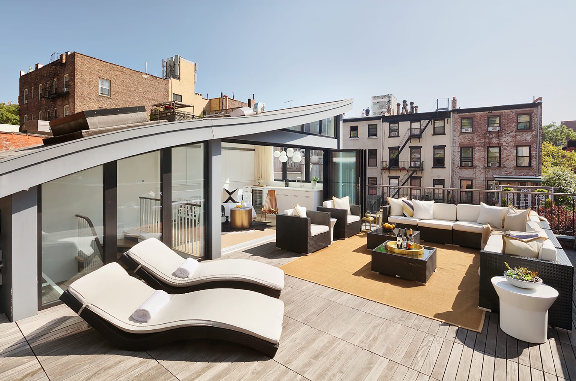 New penthouse with a curved roofline and finished roof deck on top of a Brooklyn Heights carriage house