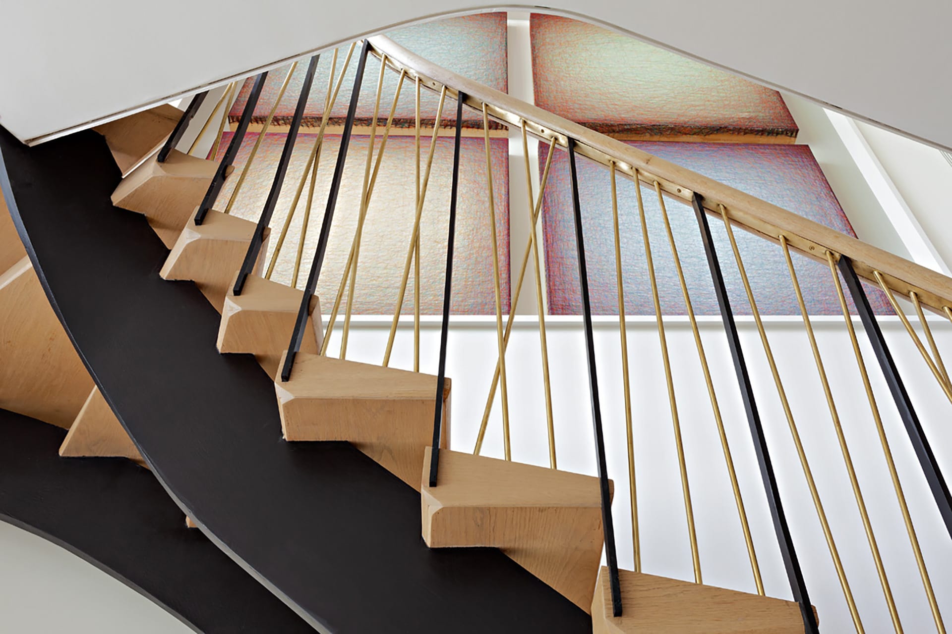 Staircase with custom risers to match a set of four paintings in a custom niche