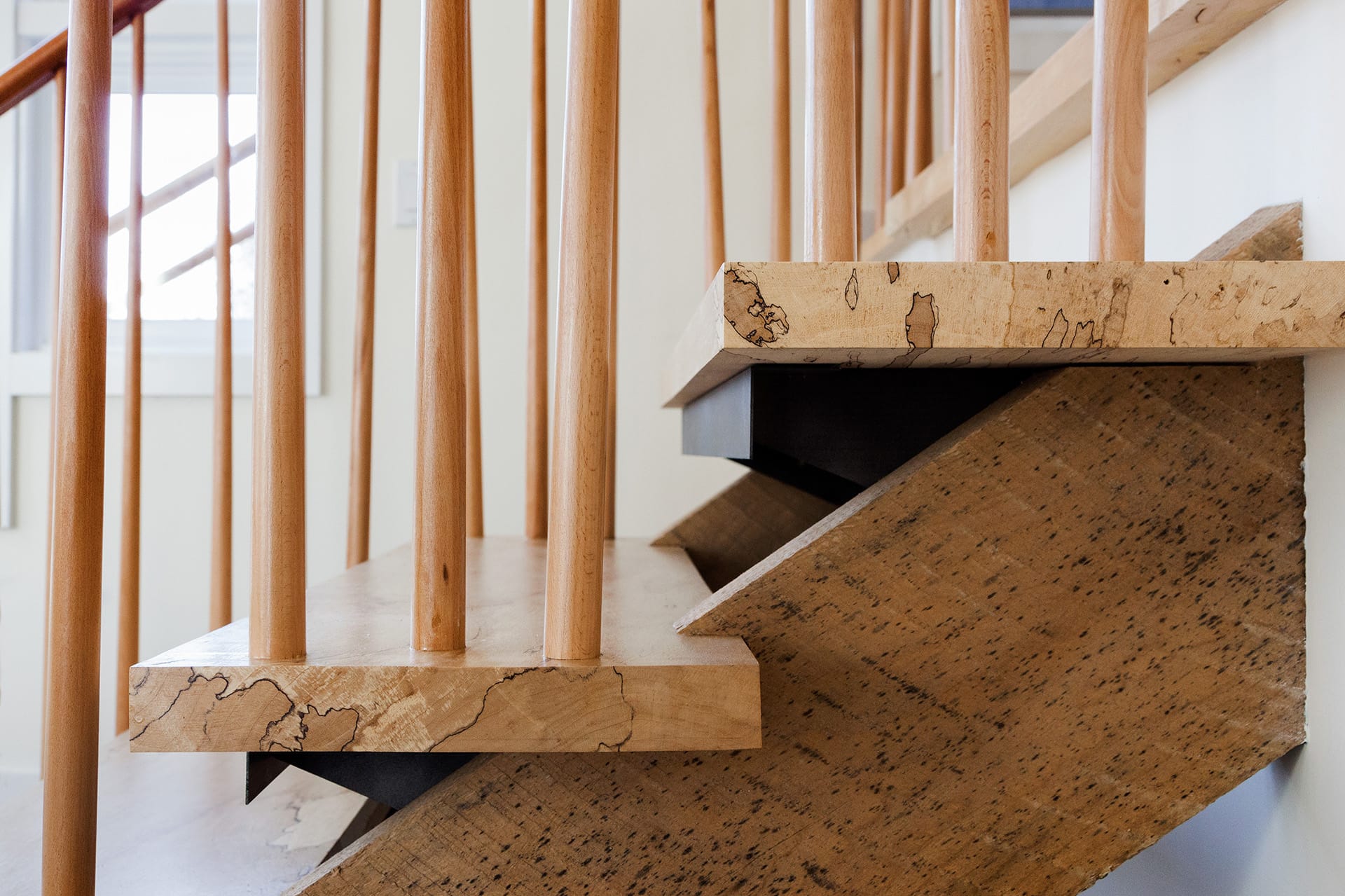 Detail of an entry staircase custom made from reclaimed wood.