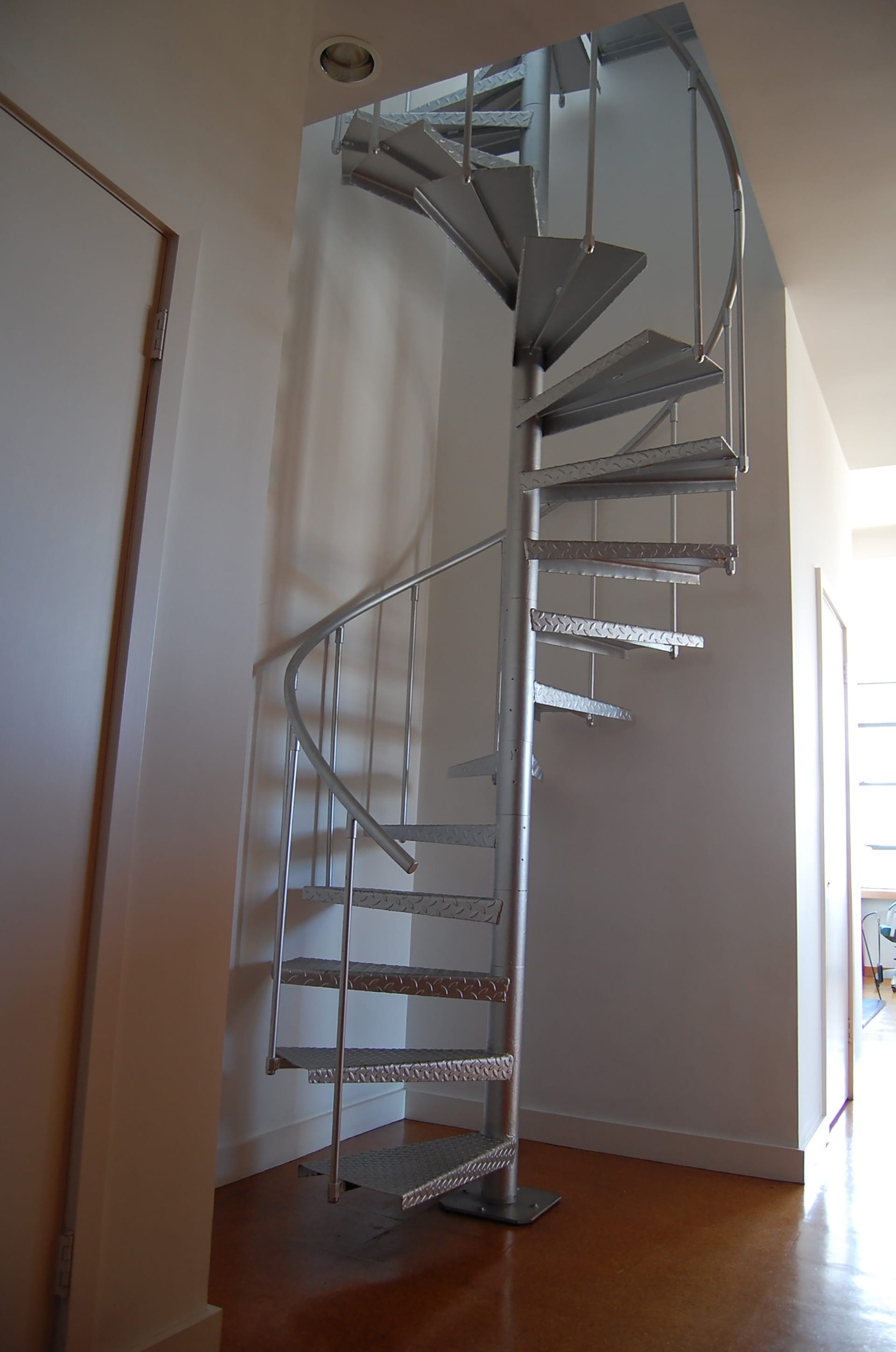 Metal spiral staircase in a West Village penthouse before our renovation.