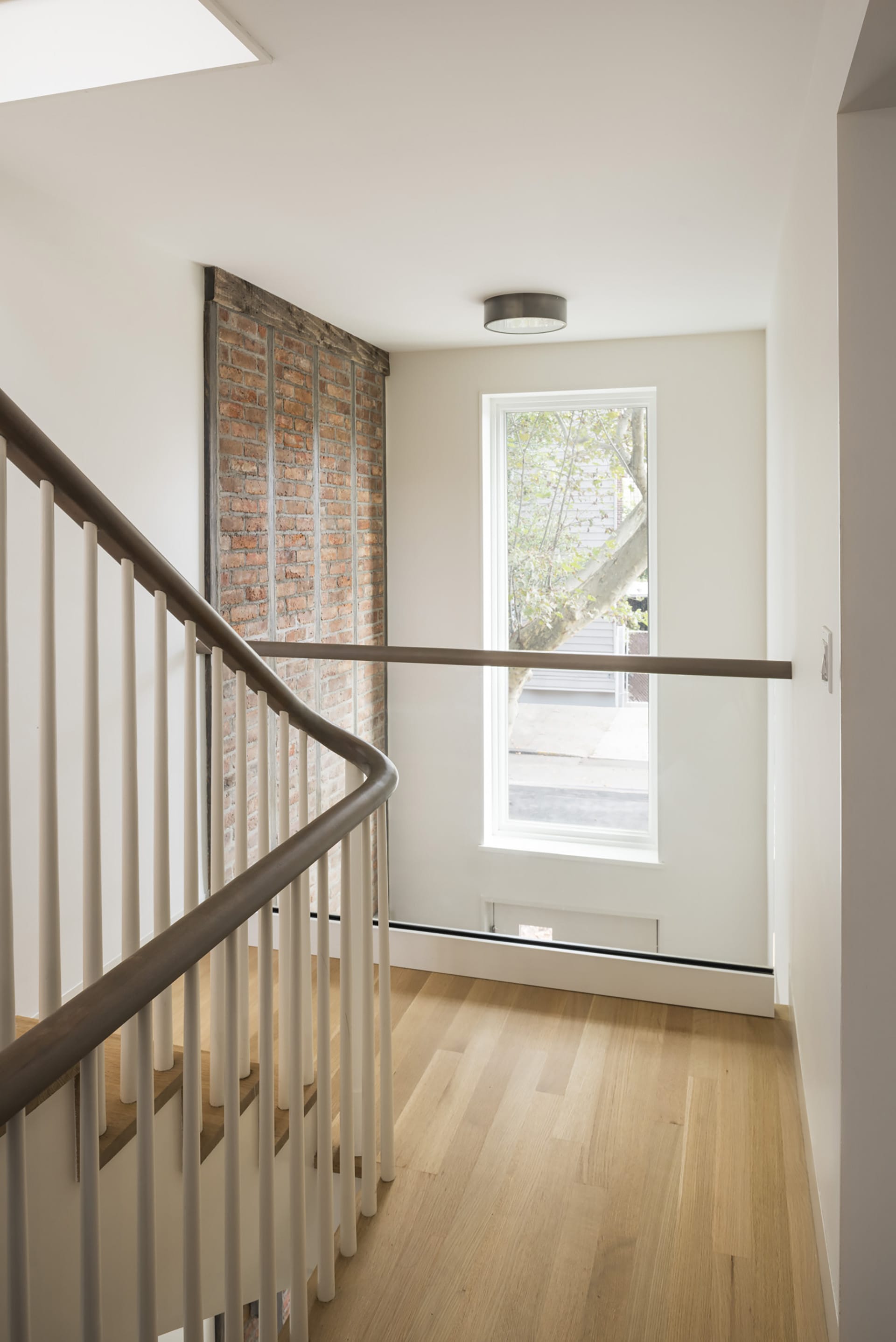 Stair hallway and double height space at the front of a Greenpoint townhouse after renovation